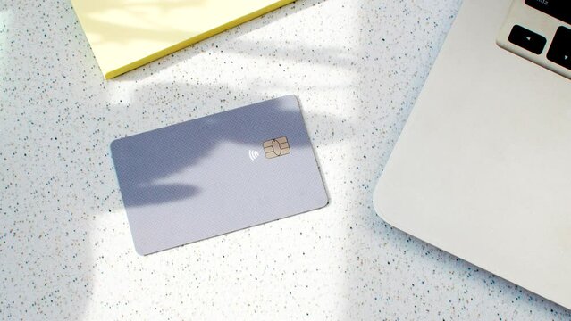 Credit card and laptop, the modern duo for secure and efficient purchases. Credit card beside a laptop, symbolizing online transactions and financial convenience.