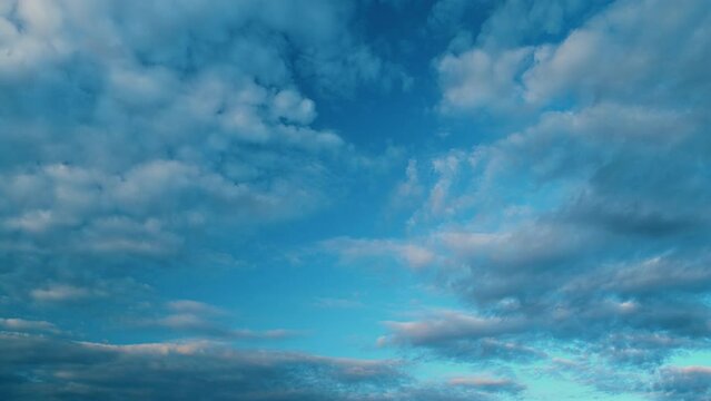 Rolling patches of cirrocumulus clouds. Beautiful sunny blue sky with cirrocumulus clouds slowly moved in autumn sky.