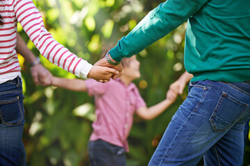 Family, holding hands and kids dance in garden or play game in summer together in a circle at park....