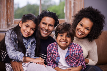 Parents, children and portrait at family in home for bonding connection on weekend, holiday or apartment. Mother, father and siblings with face in living room for happy care together, love or calm