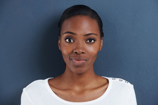 Black woman, portrait and doubt in studio with confused, thinking and unsure of planning. African model, question or smirk face with expression of whatever for decision or closeup by blue background