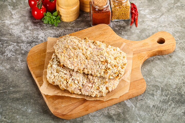 Breaded raw breaded meat schnitzel