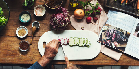 Hands using knife chopping a zucchini - obrazy, fototapety, plakaty