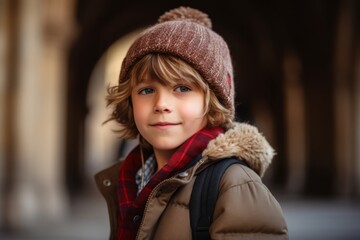 Portrait of a cute little boy in winter coat and hat.