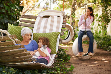 Grandmother, cat and children in a backyard, relax and bonding together with weekend break and happiness. Family, granny and grandkids with pet and playing with nature and outdoor for fresh air - obrazy, fototapety, plakaty