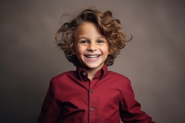 Portrait of a cute little boy in a red shirt. Studio shot.