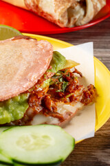 A closeup view of a mulita al pastor.