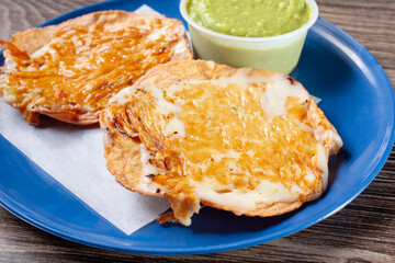 A closeup view of a tostada con queso.
