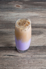 A view of a cold taro latte beverage.