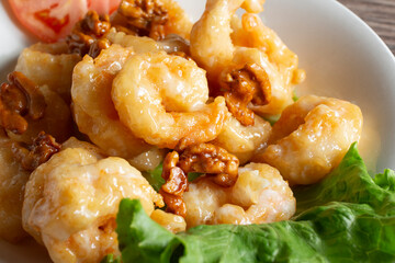 A closeup view of a plate of honey walnut shrimp.