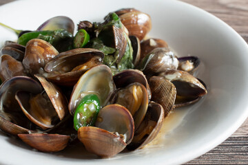 A closeup view of a clams with mint sauce.