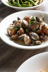 A view of a plate of clams with mint sauce.