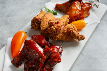 A view of a tray of assorted chicken wings.