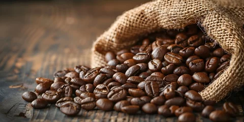 Poster Overflowing Burlap Sack of Freshly Roasted Coffee Beans on Rustic Wooden Table with Warm,Rich Tones and Unrivaled Aroma © Bussakon