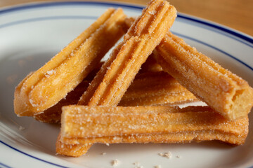A closeup view of a plate of churros.