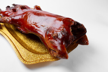 A view of the back end of a whole roasted pig.