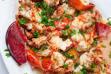 A closeup view of a garlic scallion lobster entree.