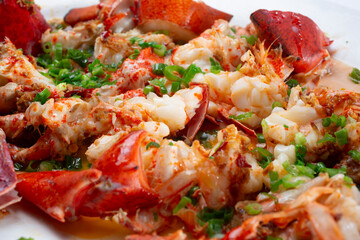 A closeup view of a garlic scallion lobster entree.