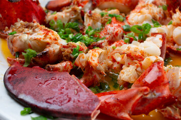 A closeup view of a garlic scallion lobster entree.