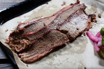 A view of three slices of brisket on a tray.
