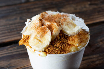 A closeup view of a cup of banana pudding.