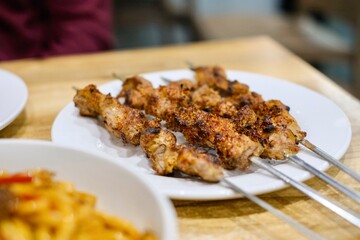 A plate of Xinjiang-style spiced cumin lamb skewers at Apandim Uyghur Restaurant in Burwood Chinatown - Sydney, NSW
