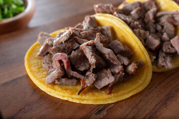 A closeup view of carne asada tacos.
