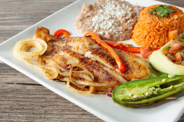 A view of a plate of pescado al mojo de ajo.