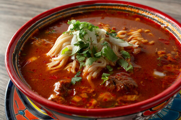 A closeup view of a bowl of ramen birria.