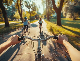 Cyclist's view on park trail. First-person perspective of cyclist's hands on handlebars riding on park trail looking at other cyclists