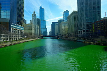 View of Chicago city with the river dyed green for St Patrick's day celebration - 764507981