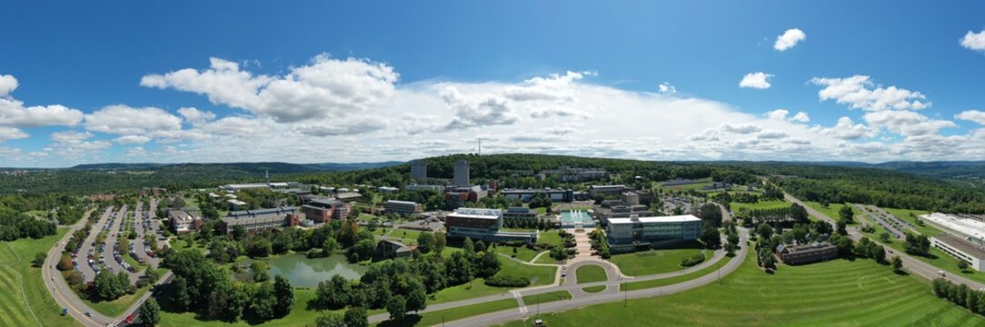Ithaca College campus in Ithaca, NY on summer day. Wide aerial drone panorama taken on July 17, 2019. 