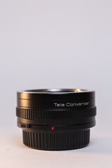 Fototapeta na wymiar Black camera telephoto lens converter on white background