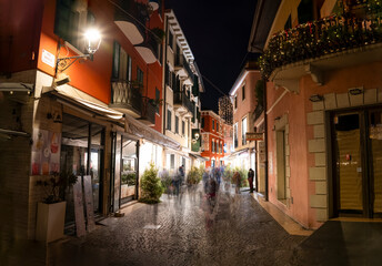 Fototapeta na wymiar A Peschiera del Garda city walk during winter Christmas time and already night conditions