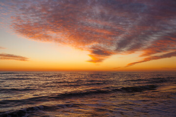 Naklejka na ściany i meble sunset on the sea beautiful waves