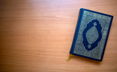 The Qur'an, the holy book of Muslims on a wooden table