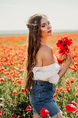 Woman poppies field. Side view of a happy woman with long hair in a poppy field and enjoying the beauty of nature in a warm summer day.