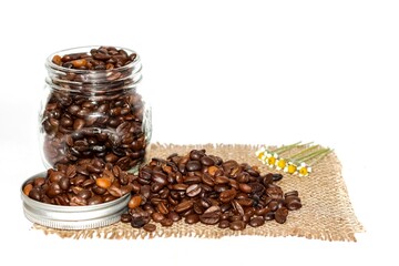 Photo of vintage style with coffee beans and coffees powder in the portafilter to make espresso coffee shots with white background.