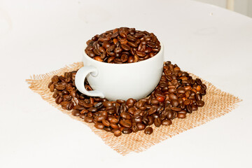 Coffee beans put on the cup on white background in concept isolate pictures.