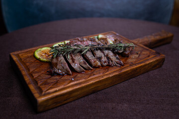 Beef steak with grilled zucchini on a wooden board
