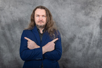 Confident man with long hair in stylish blue suit striking various professional poses