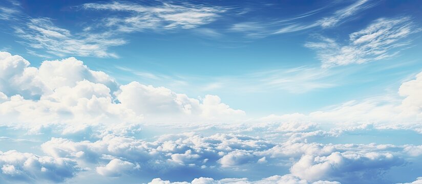 A peaceful scene of a modern aircraft flying high in the sky amongst scattered fluffy clouds