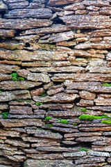 Rockery of slate stone with green moss