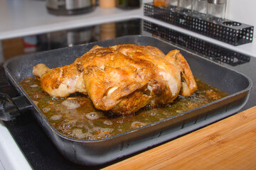 Fried chicken in a frying pan. Grilled chicken at home