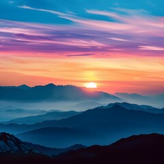 Naklejka premium A stunning sunset scene over a mountain range with vibrant colors in the sky and dramatic silhouettes of the mountains.