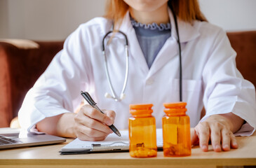 Doctor records health examination results and medication usage of patient, pill bottle, healthcare, and medical checkup concept