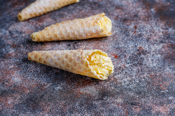 Homemade nut shaped russian soviet cookies and wafer rolls with pastry cream.
