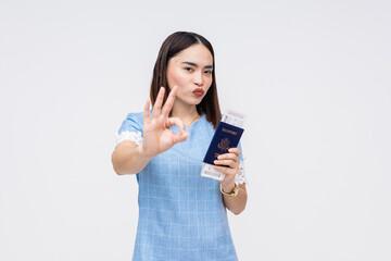 Asian woman with passport and boarding pass making OK sign, ready for travel
