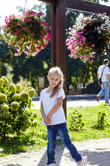 Little girl walk  in the summer city park. Childhood, leisure and people concept - happy child rest and have a good time