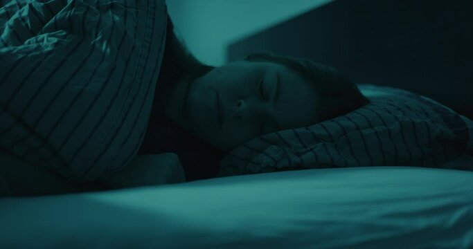Close up of woman turning in bed and falling asleep